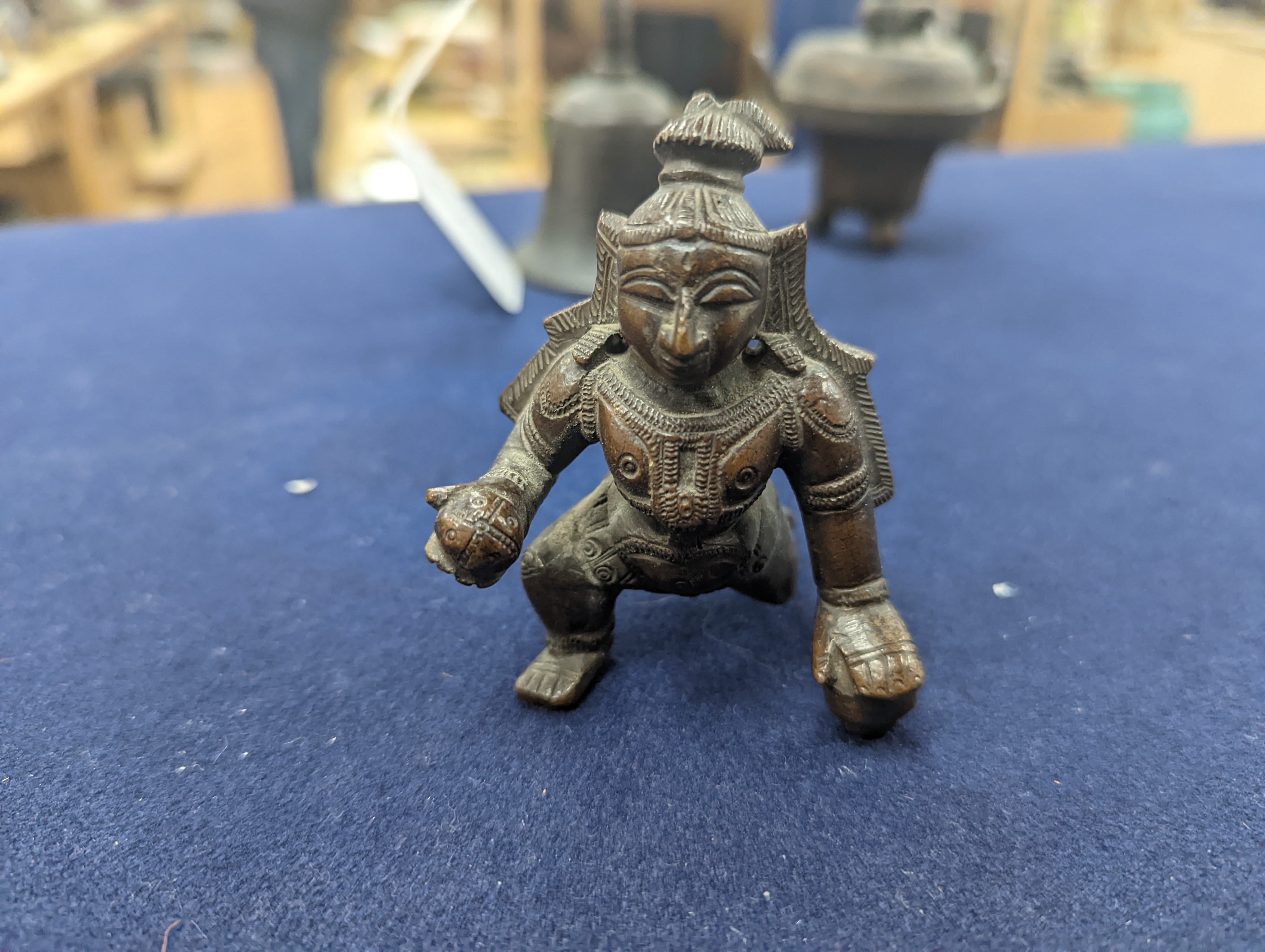 A Chinese gilt copper figure, a Chinese Dog of Fo, a bell, a censer, six Indian bronze figures and a scroll box